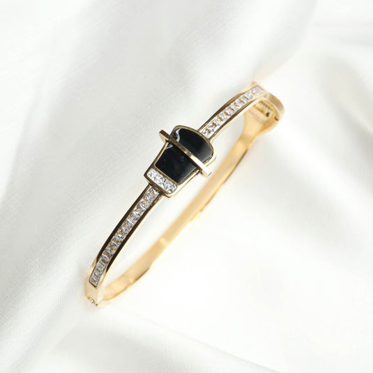 QuinShine luxury black stone bracelet with gold band and embedded clear crystals on white fabric