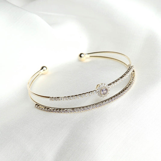 QuinShine luxury double band bracelet with gold finish and sparkling crystal accents on white fabric