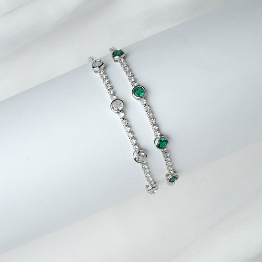QuinShine luxury emerald jewelry featuring two silver bracelets with emerald and clear stones
