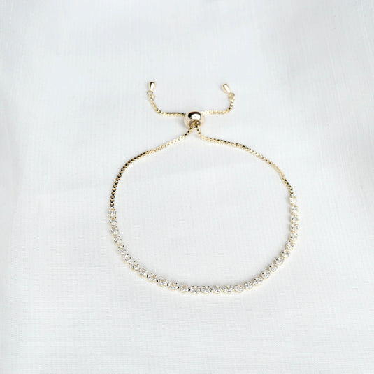 QuinShine luxury gold tennis bracelet with adjustable chain and sparkling stones on white background