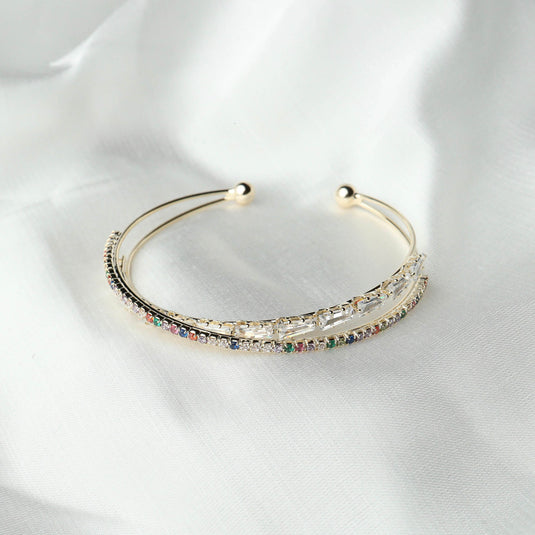 QuinShine delicate gold cuff rainbow gemstone bracelet with multicolored stones on white fabric