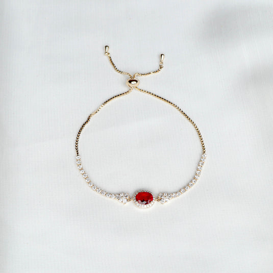 Elegant ruby gemstone bracelet with a red central stone and adjustable gold chain by QuinShine