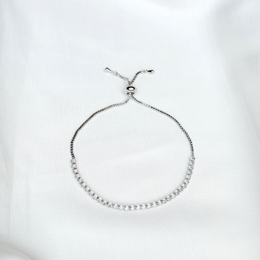 QuinShine luxury tennis bracelet with adjustable silver chain and sparkling stones on white background