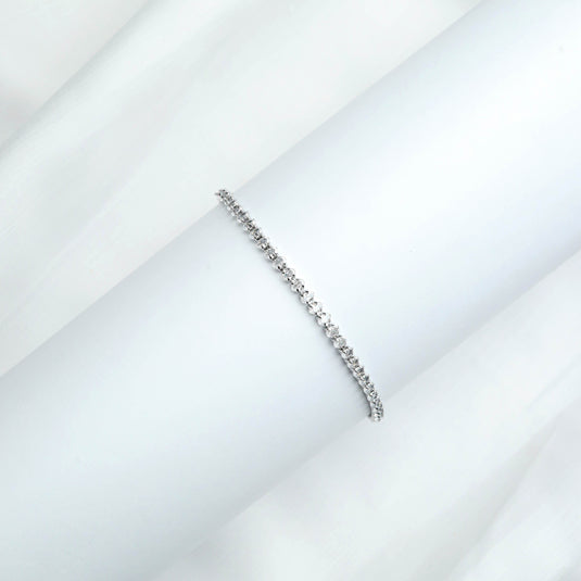 QuinShine luxury tennis bracelet with sparkling clear stones on a white background
