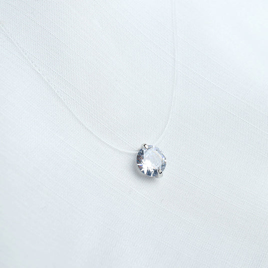 QuinShine minimalist jewelry necklace with a single clear round gemstone on a delicate transparent chain