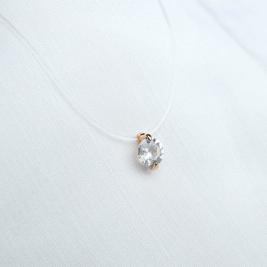QuinShine minimalist jewelry necklace with clear pendant on a delicate transparent chain