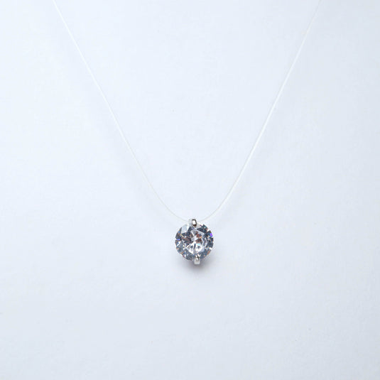 QuinShine minimalist jewelry necklace with a single round clear crystal pendant on a delicate transparent chain