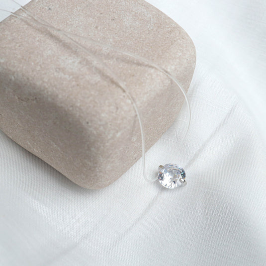QuinShine minimalist jewelry necklace with a clear chain and single sparkling gemstone pendant