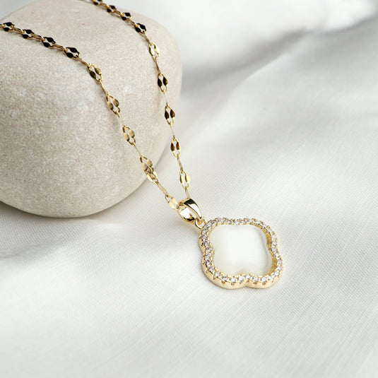 Elegant Moroccan flower necklace with gold chain and white gemstone pendant surrounded by small crystals