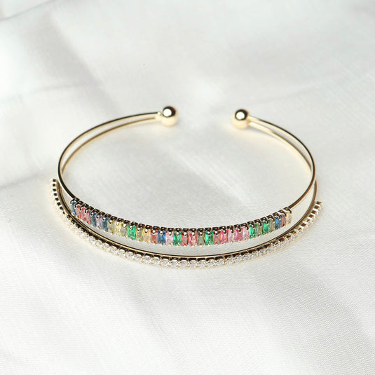 QuinShine elegant gold-tone multicolor jewelry bracelet with colorful stones on white fabric background