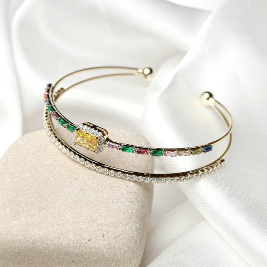 QuinShine Radiant Arc Bracelet featuring colorful gemstones and elegant design on a soft backdrop