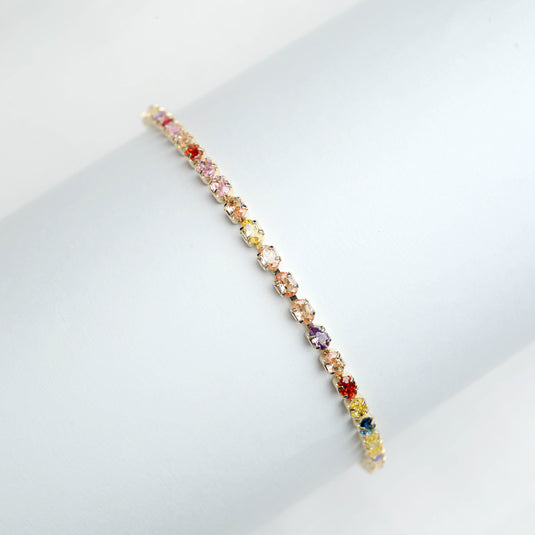 QuinShine rainbow tennis bracelet featuring multicolored gemstones set in a delicate gold chain