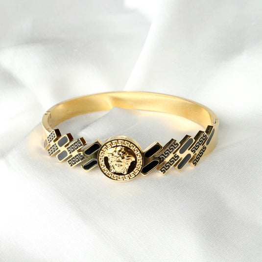 QuinShine gold Regal Medallion Bracelet featuring intricate black enamel details and a bold medallion centerpiece