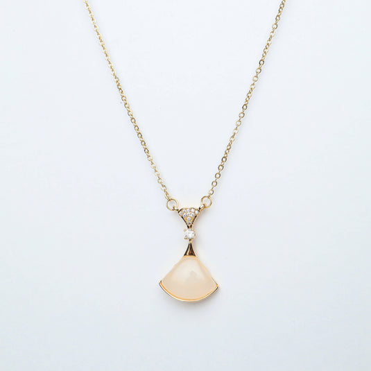 Delicate rose quartz pendant jewelry with gold chain and small accent stones by QuinShine
