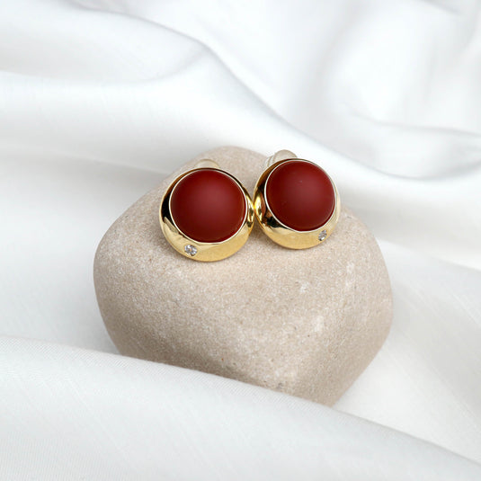 QuinShine scarlet sphere stud earrings with gold setting and small diamond detail on beige stone