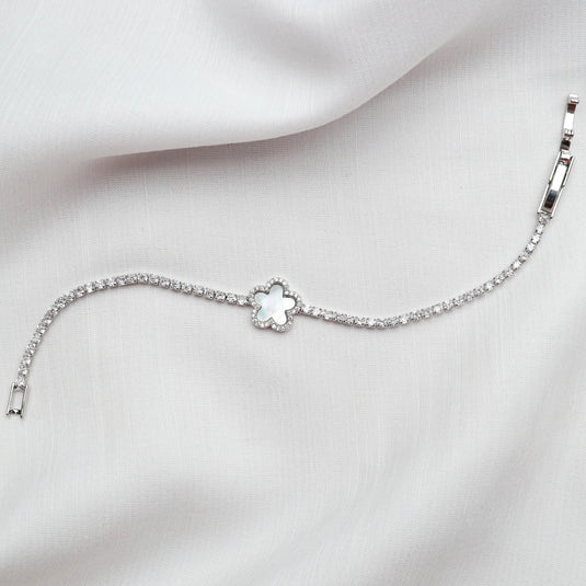 QuinShine Silver Clover Charm Bracelet with delicate chain and clover centerpiece on white fabric
