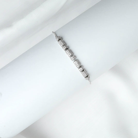 QuinShine elegant wrist bracelet with sparkling stones on a white display holder