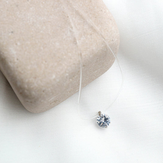 QuinShine solitaire transparent necklace with a single sparkling pendant on clear cord