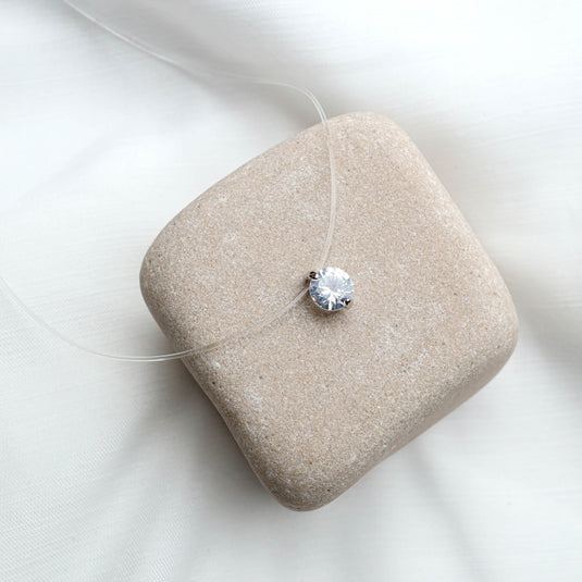 QuinShine solitaire transparent necklace with a single sparkling round pendant on a clear cord