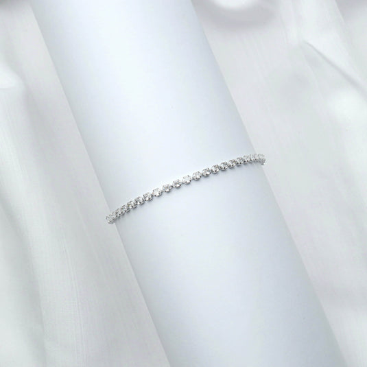 QuinShine thin diamond Line bracelet for women displayed on a white cylindrical stand