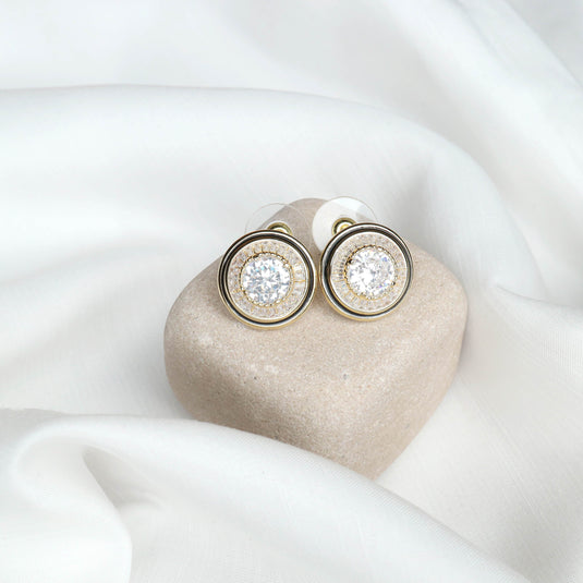 QuinShine earrings featuring a unique cosmic earrings design with sparkling stones on a beige cushion