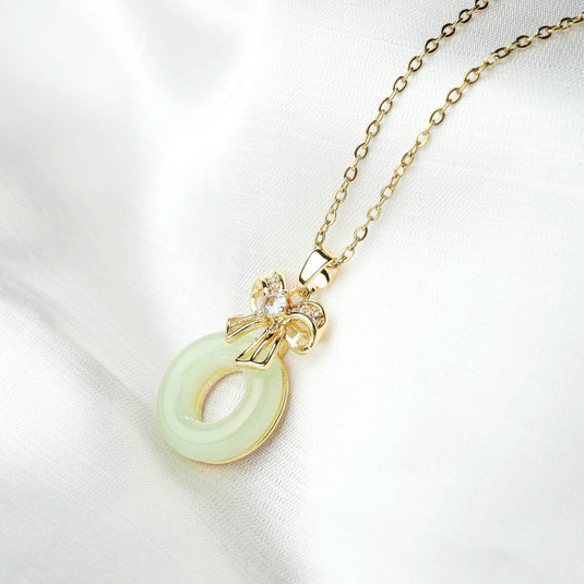 QuinShine gold chain necklace with light green circular pendant and bow detail unique gemstone jewelry