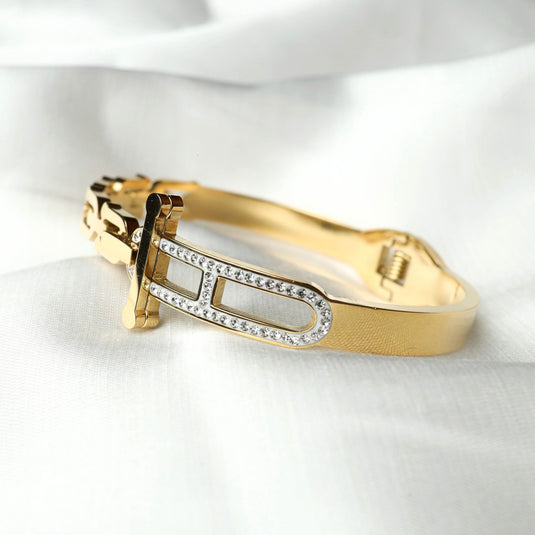 QuinShine golden equinox bracelet with gold finish and rhinestone accents on white fabric background