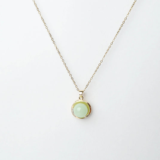 QuinShine serenity circle necklace with gold chain and light green circular pendant