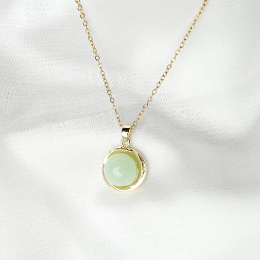 QuinShine serenity circle necklace with gold chain and light green circular gemstone pendant