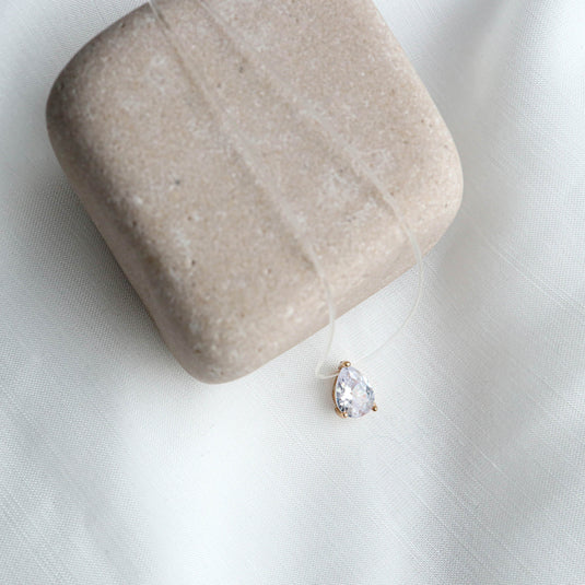 QuinShine starlight crystal pendant with a teardrop-shaped clear crystal on a delicate transparent necklace