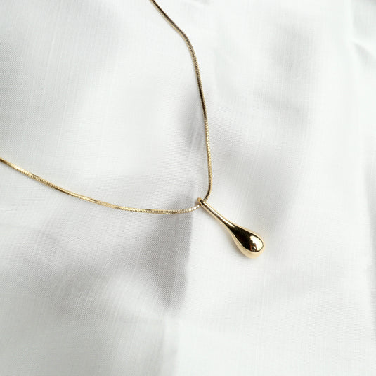 Unique gold contour drop necklace with a sleek teardrop pendant on a delicate chain