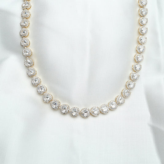 Elegant white gemstone heart necklace featuring sparkling round white gemstones set in gold-tone links